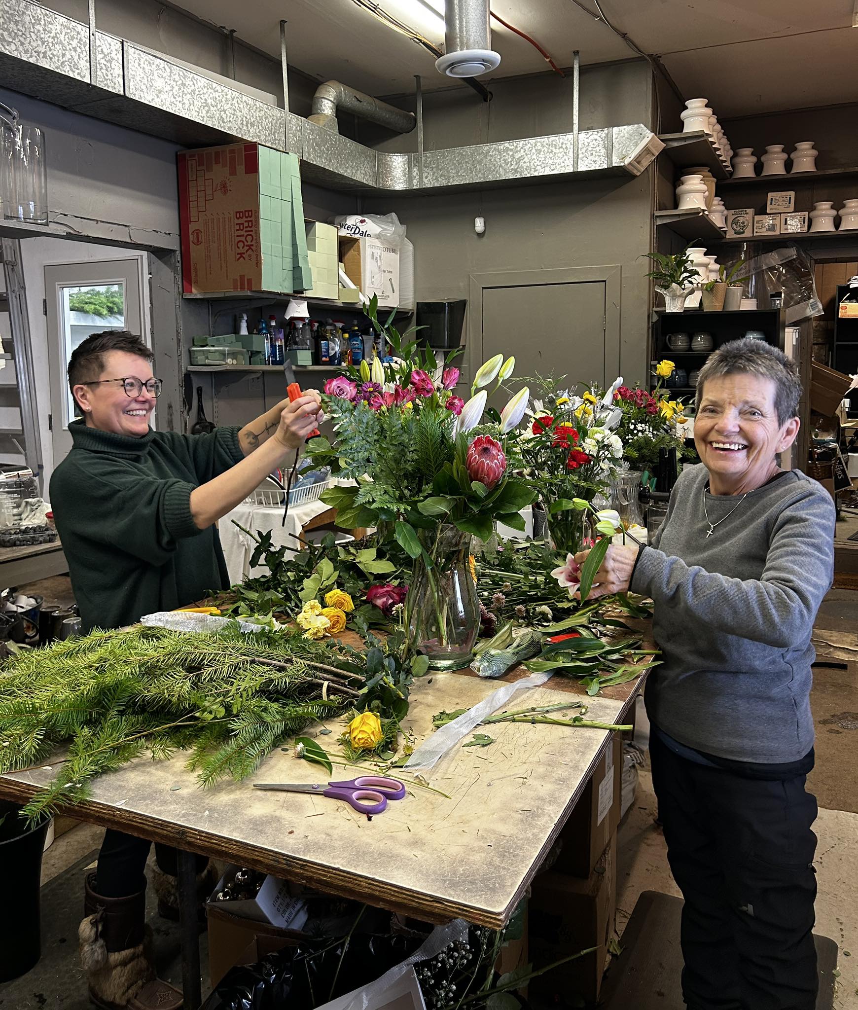 Women putting bouquets together